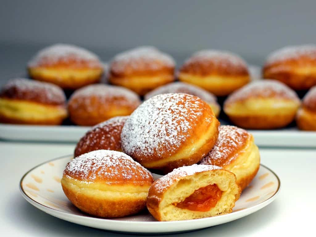 polish-donuts-with-powder-sugar-on-plates